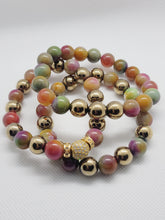 Load image into Gallery viewer, Set of colorful beaded bracelets with gold accents on a white background
